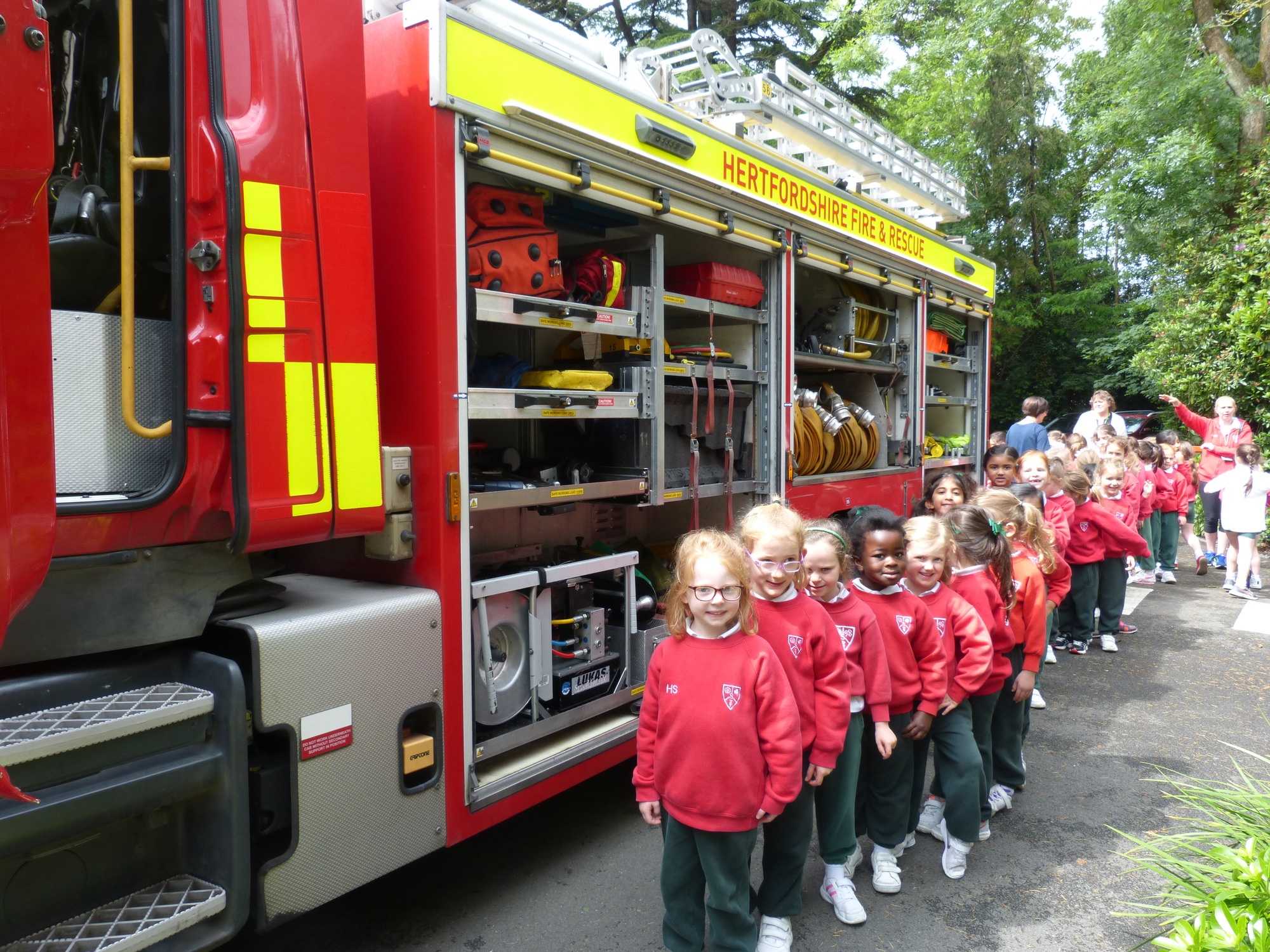 children next to a fire brigade