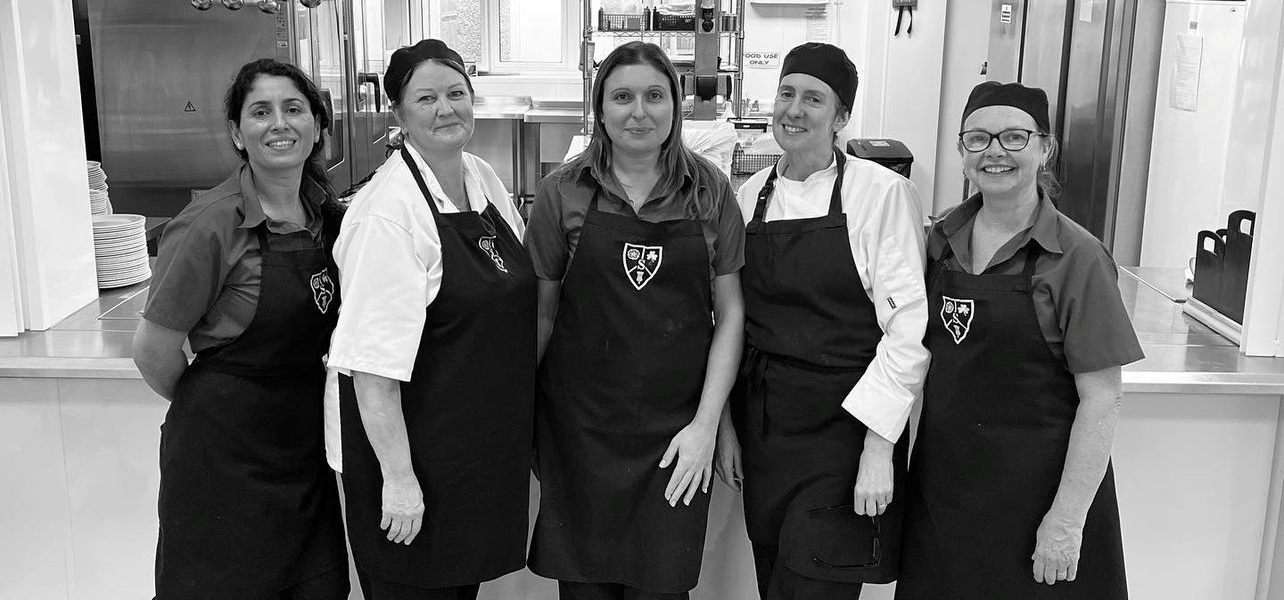 kitchen staff stood for a photo