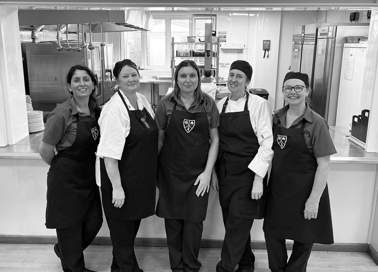 kitchen staff stood for a photo